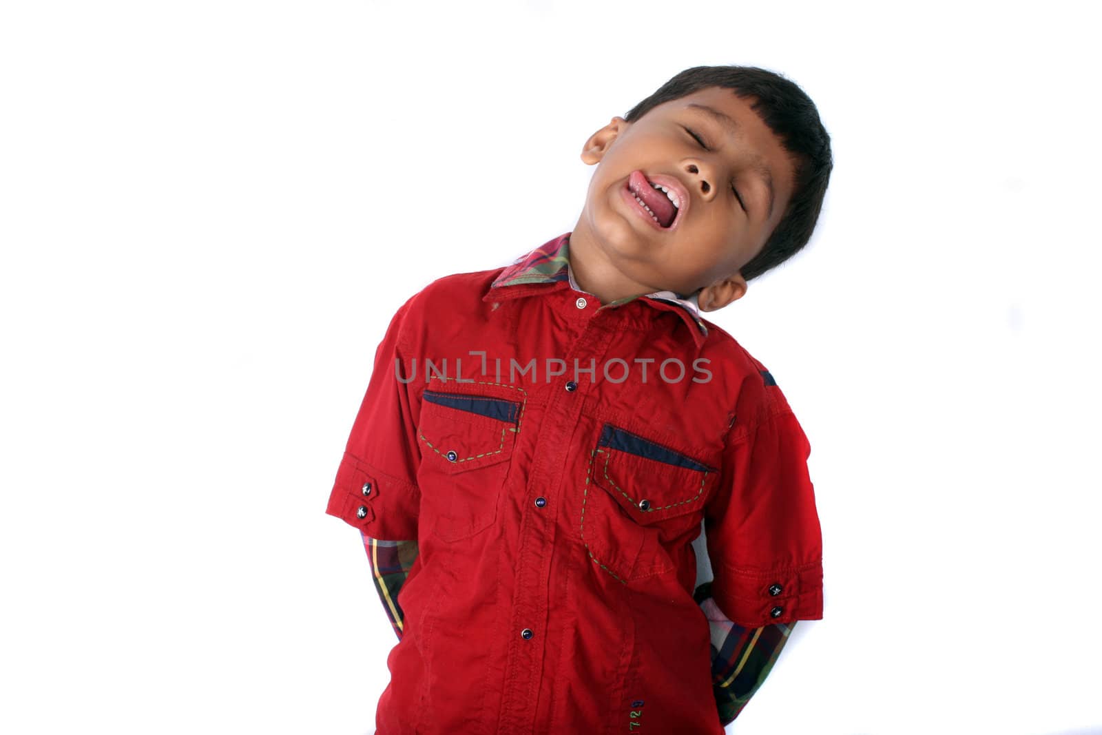 A young Indian boy fooling around by playing dead.