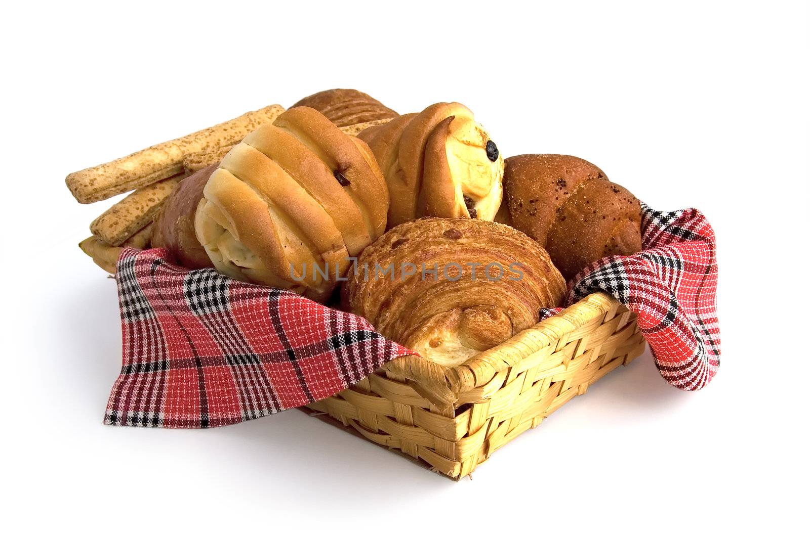 Rolls, croissants, bread sticks in a wicker basket on a red checkered napkin isolated on a white background