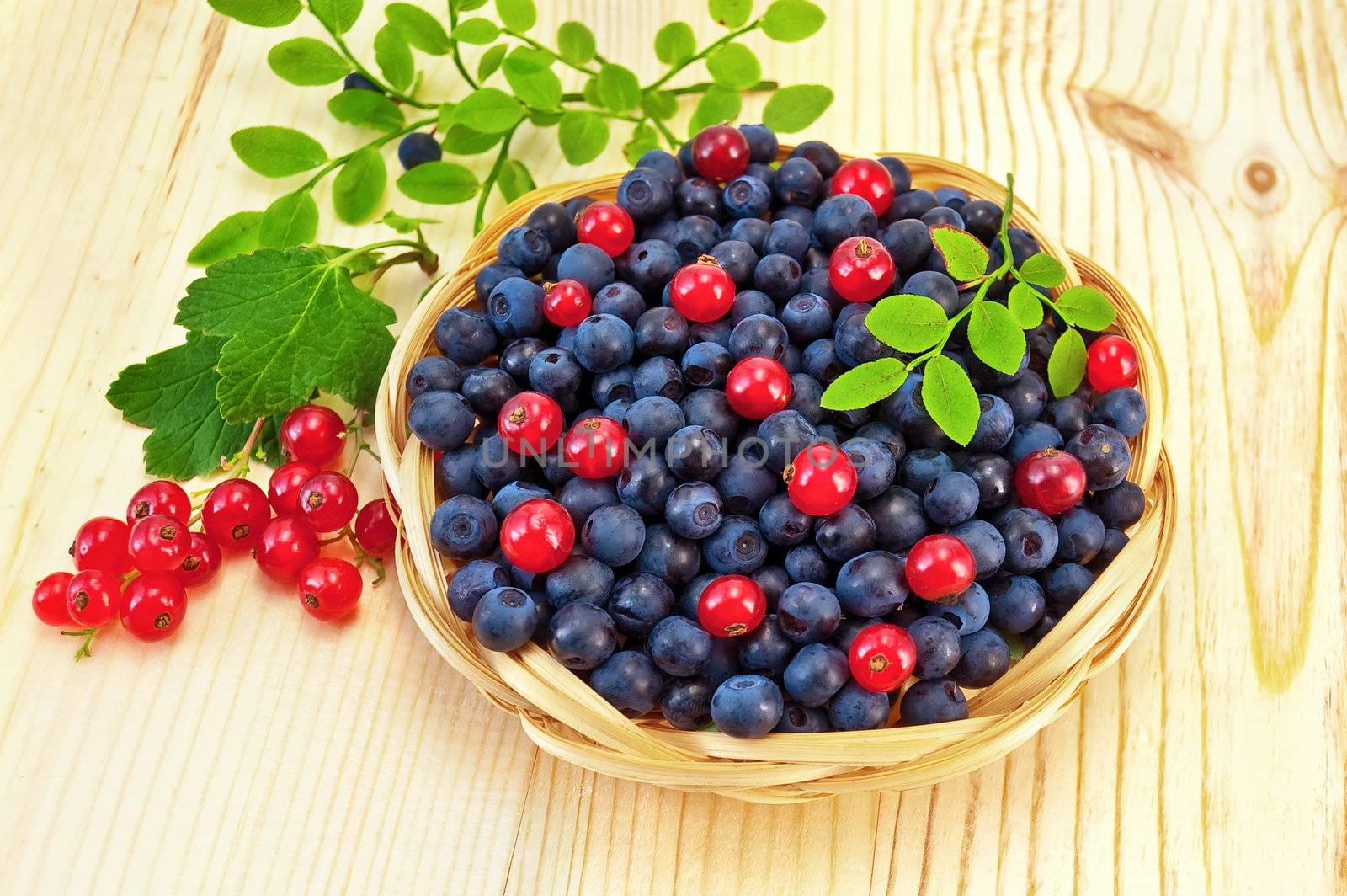 Blueberries with red currants on the board by rezkrr