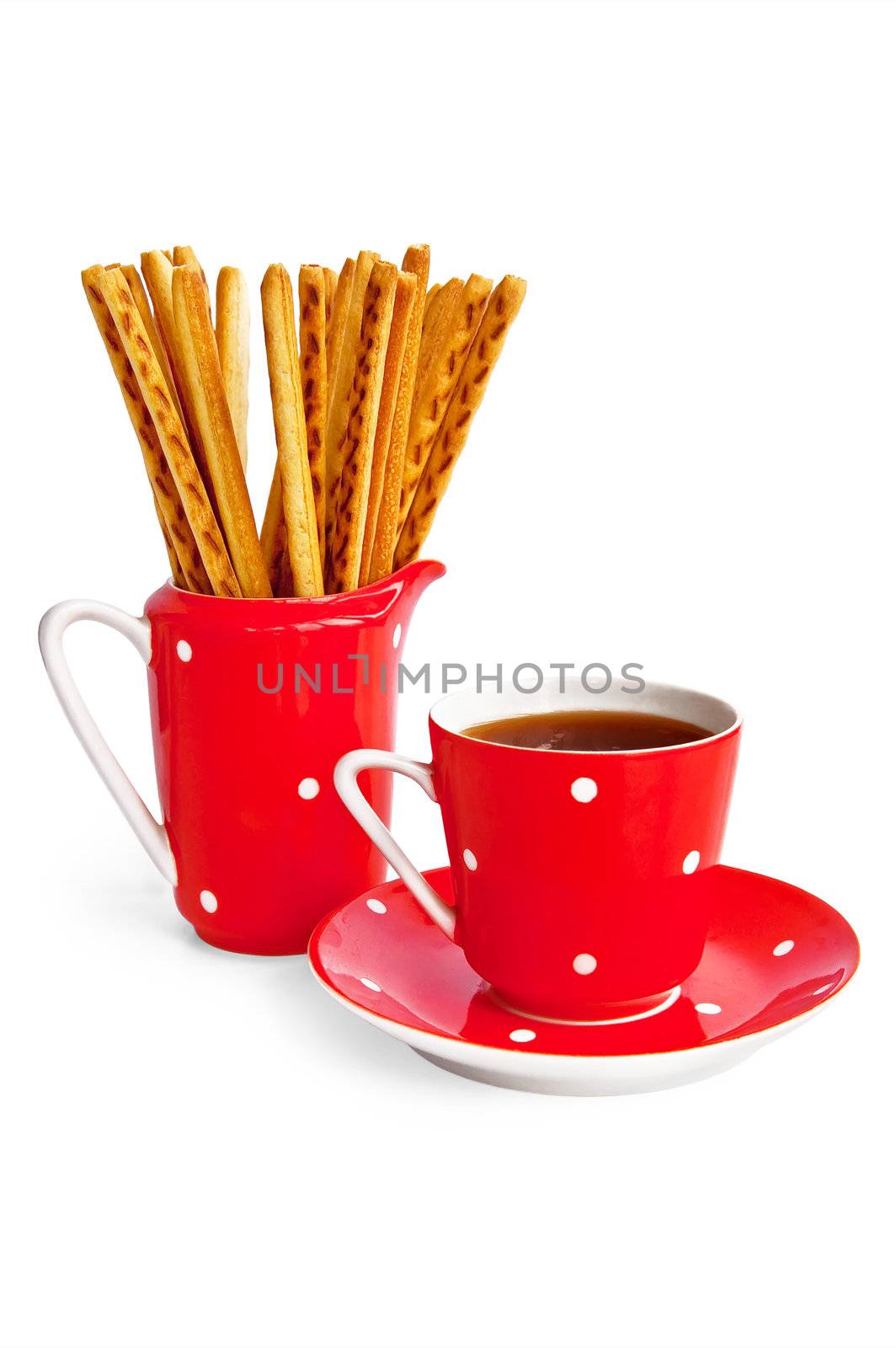 Bread sticks and coffee in the red utensil isolated on a white background