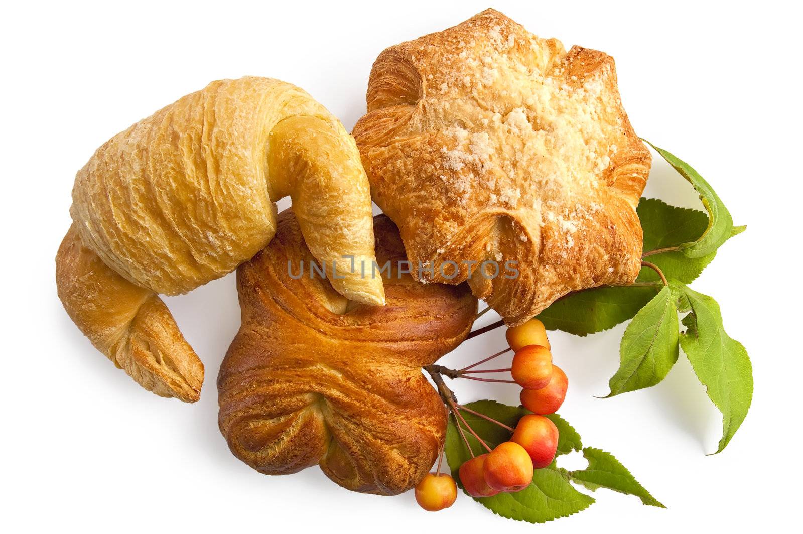 Croissant and two buns with a sprig of wild apples and green leaves isolated on white background