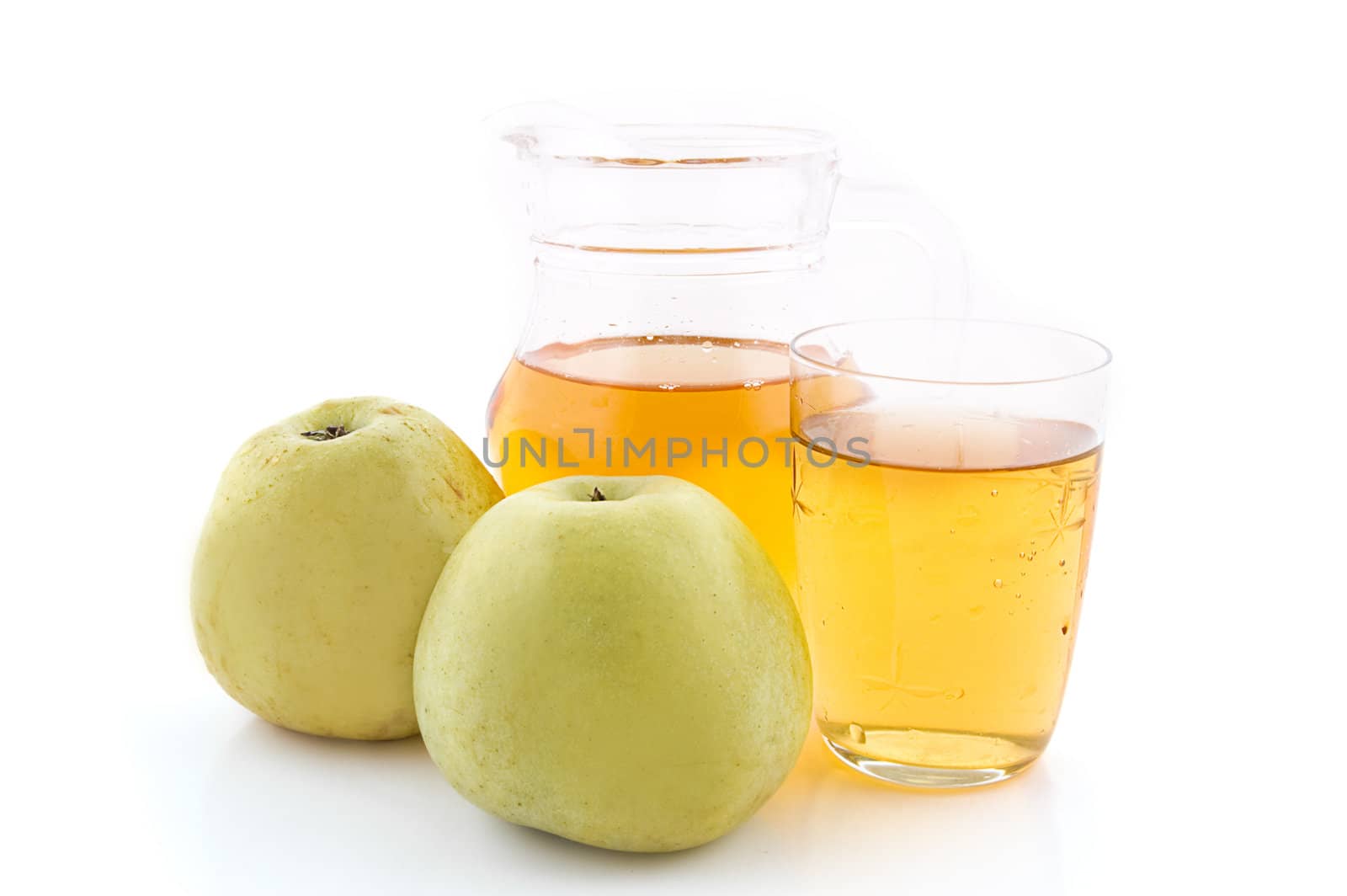 Jug and glass of green apple juice with fruit isolated on white background
