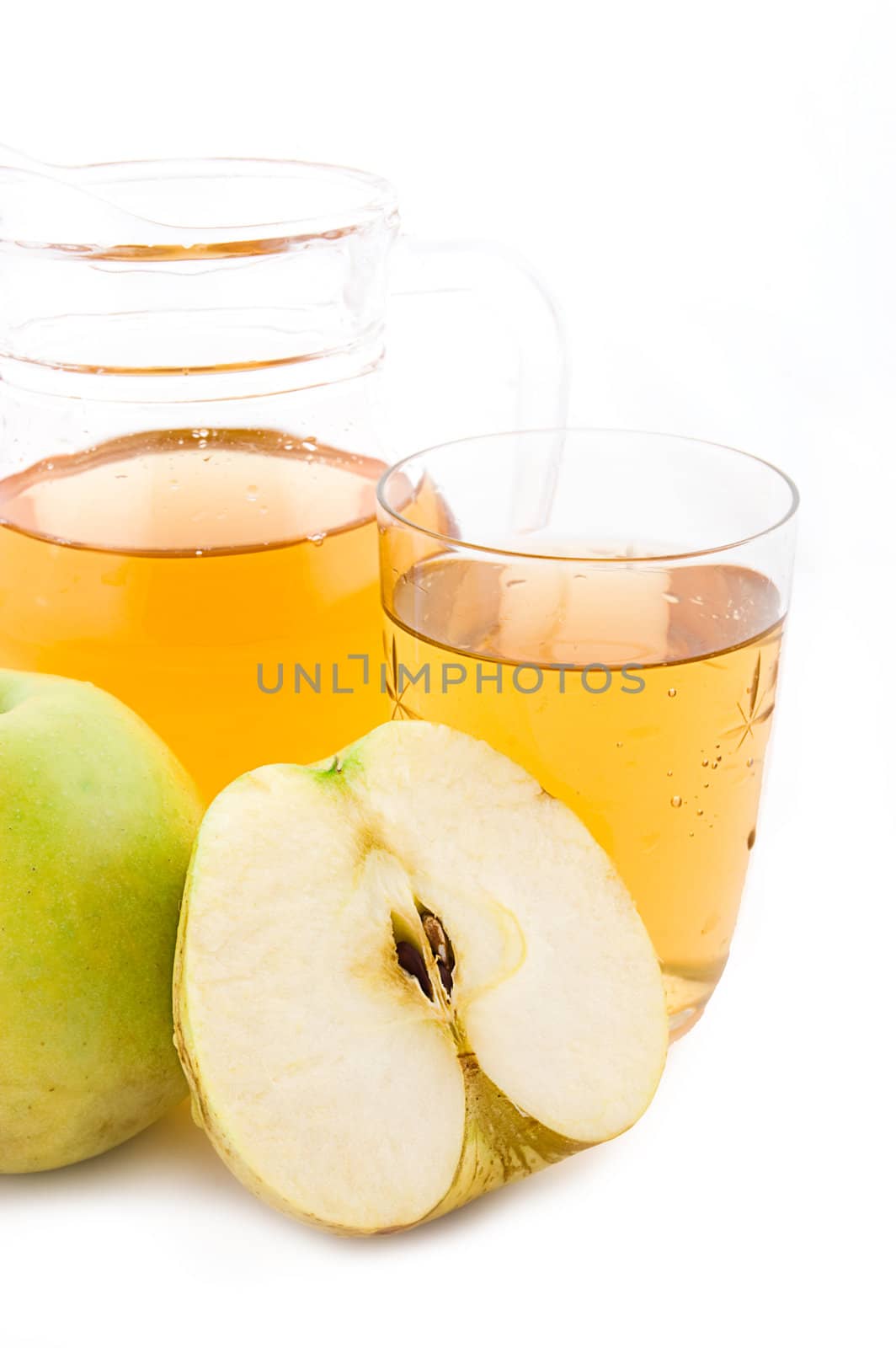 Jug and glass of green apple juice with fruit isolated on white