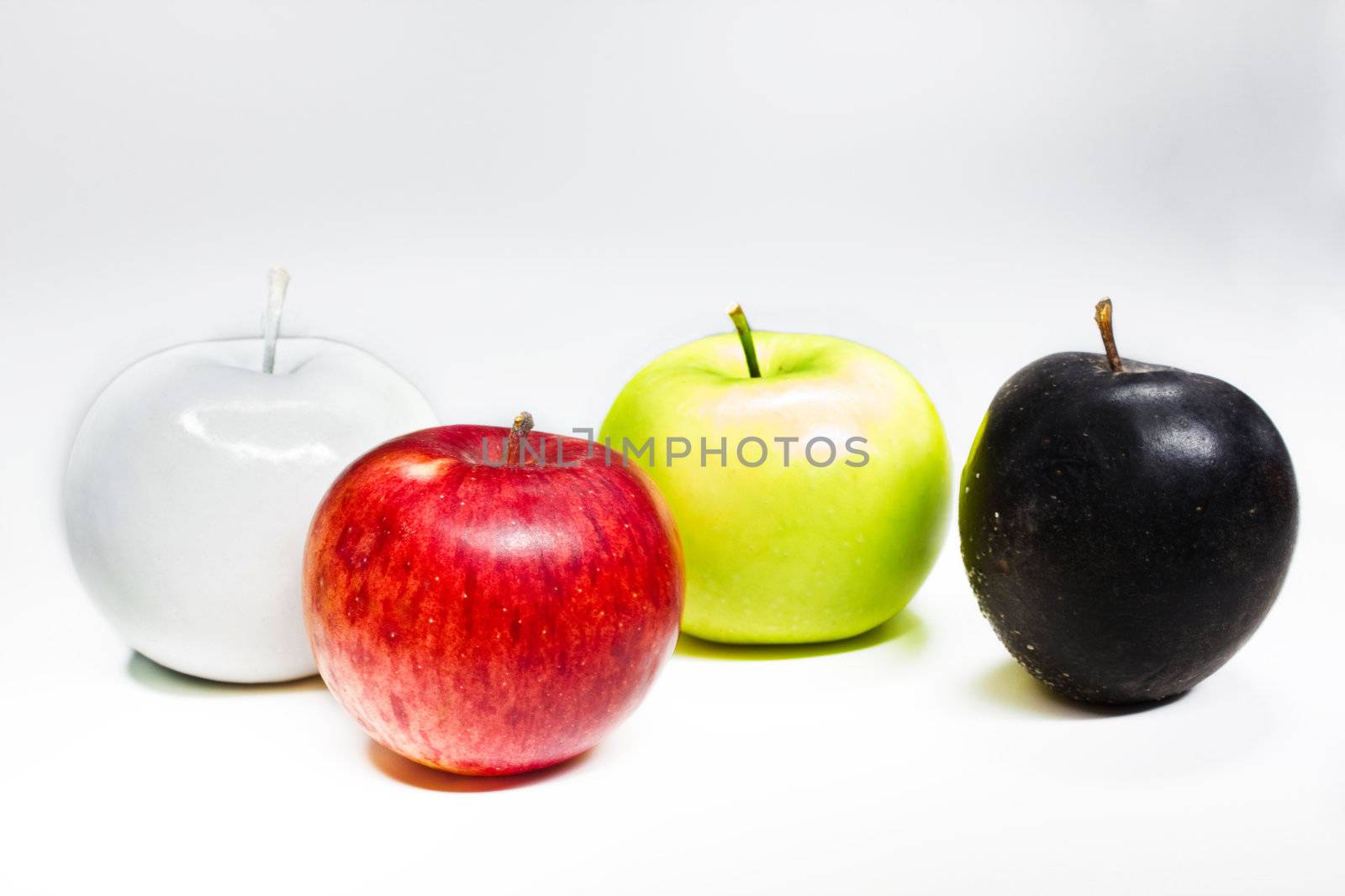 White, green, red and black apples isolated on white