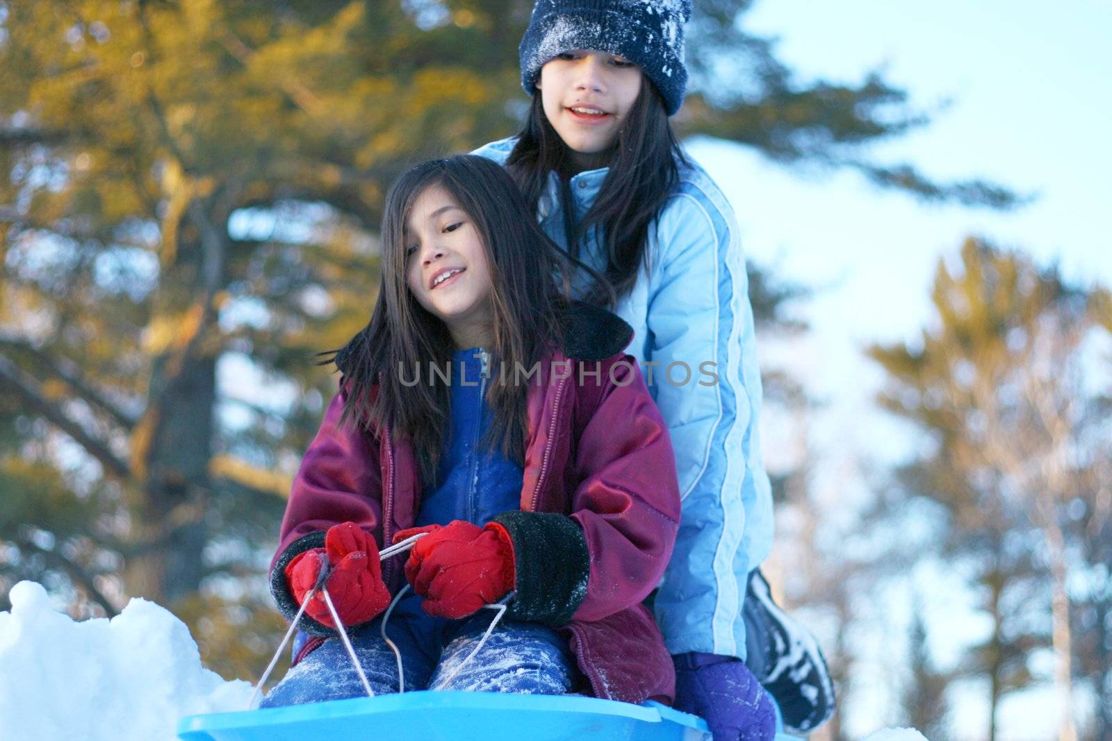 Children sledding down hill