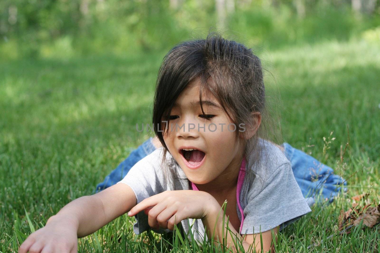 Child discovering something in the grass