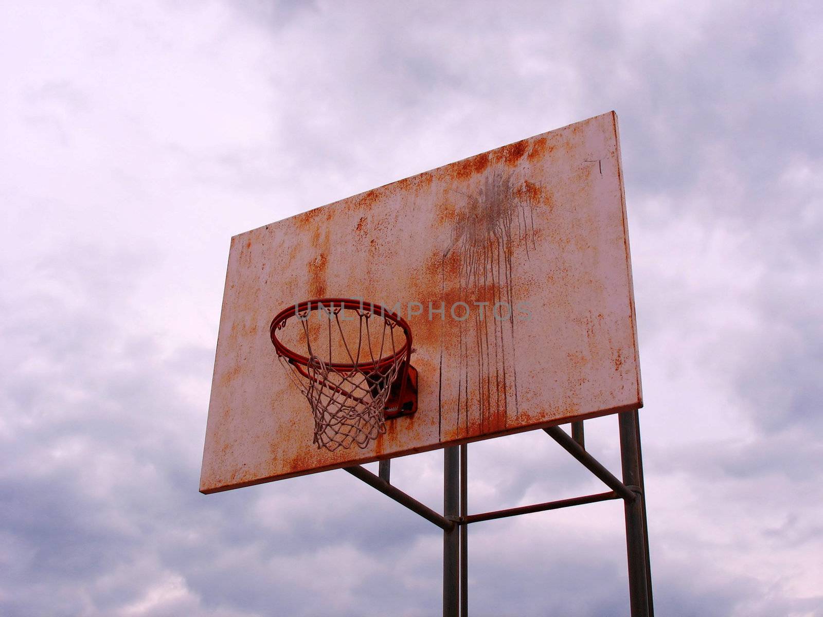 A shot of a playground basketball hoop and backboard.