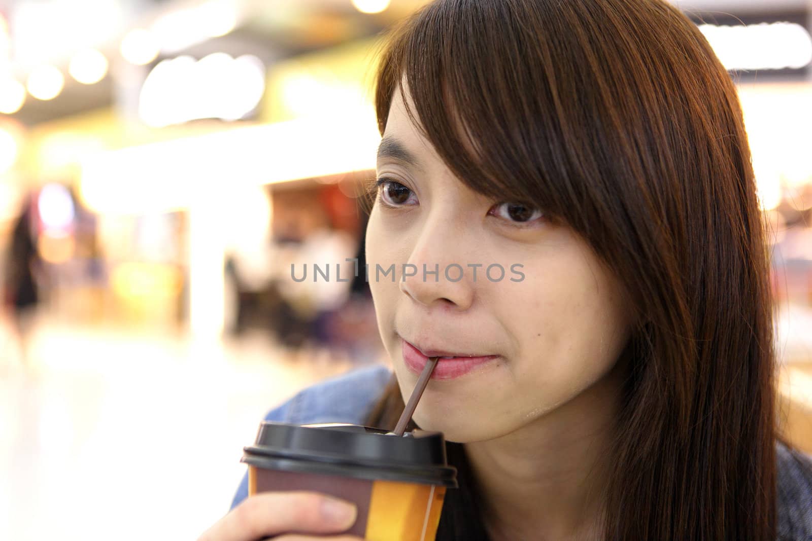 woman sitting in cafe indoor and drinking coffee