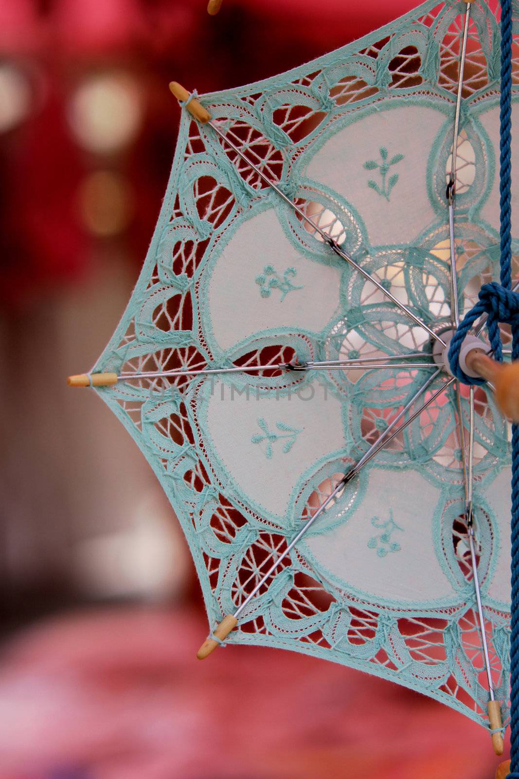 Detail of a souvenir lace umbrella, from the open market in the fishing village Marsaxlokk, a major tourist destination in Malta