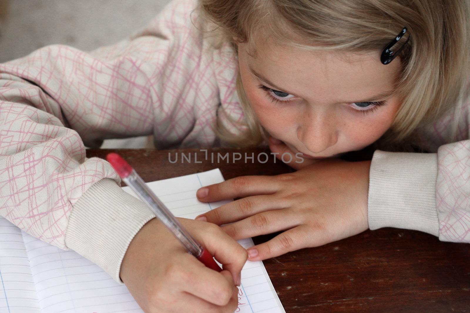 Child writing in a copy book