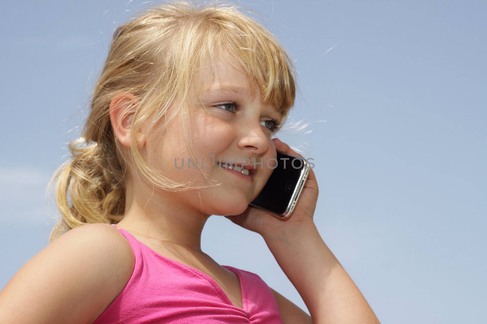 Pretty young girl talking on cell phone by annems