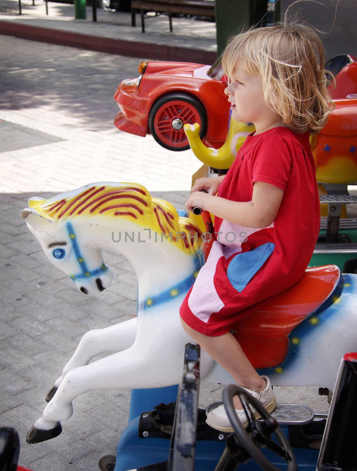 Girl riding a carousell horse by annems
