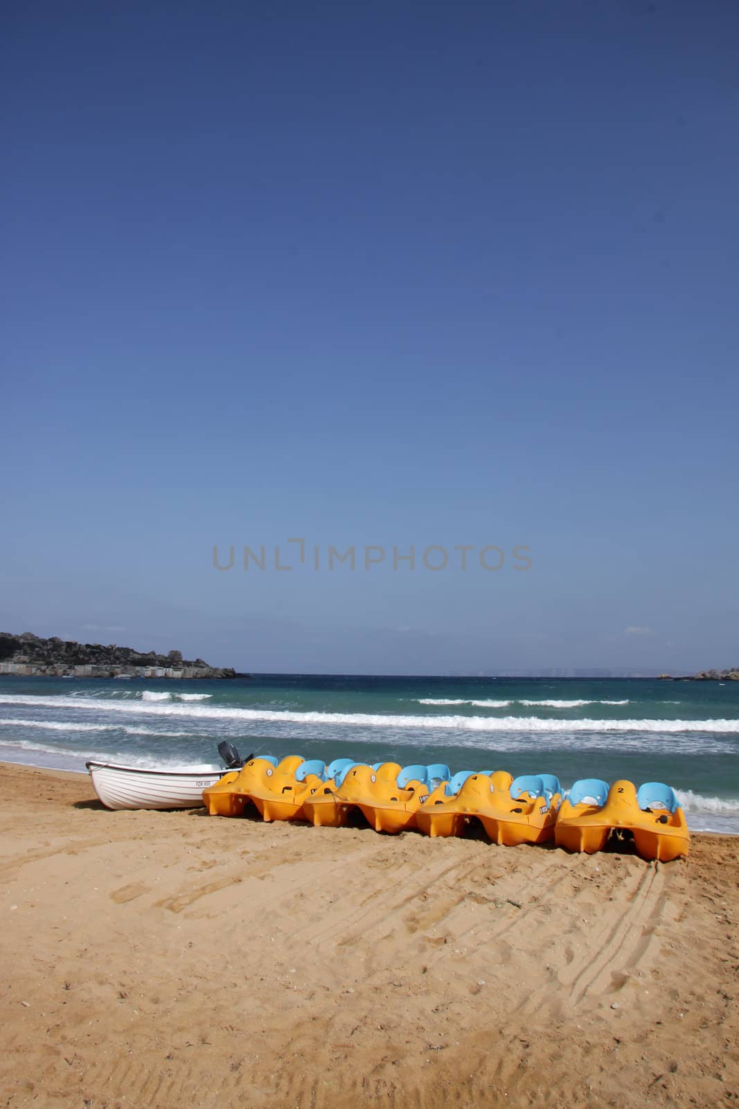 A row of peddle boats on the beach on the island of Malta, Europe