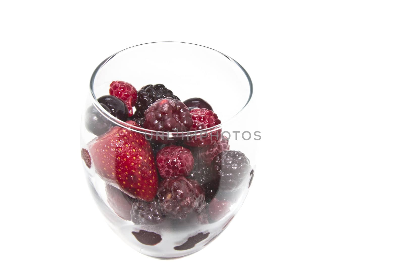 Raspberry, strawberry and blueberry served in a wine glass