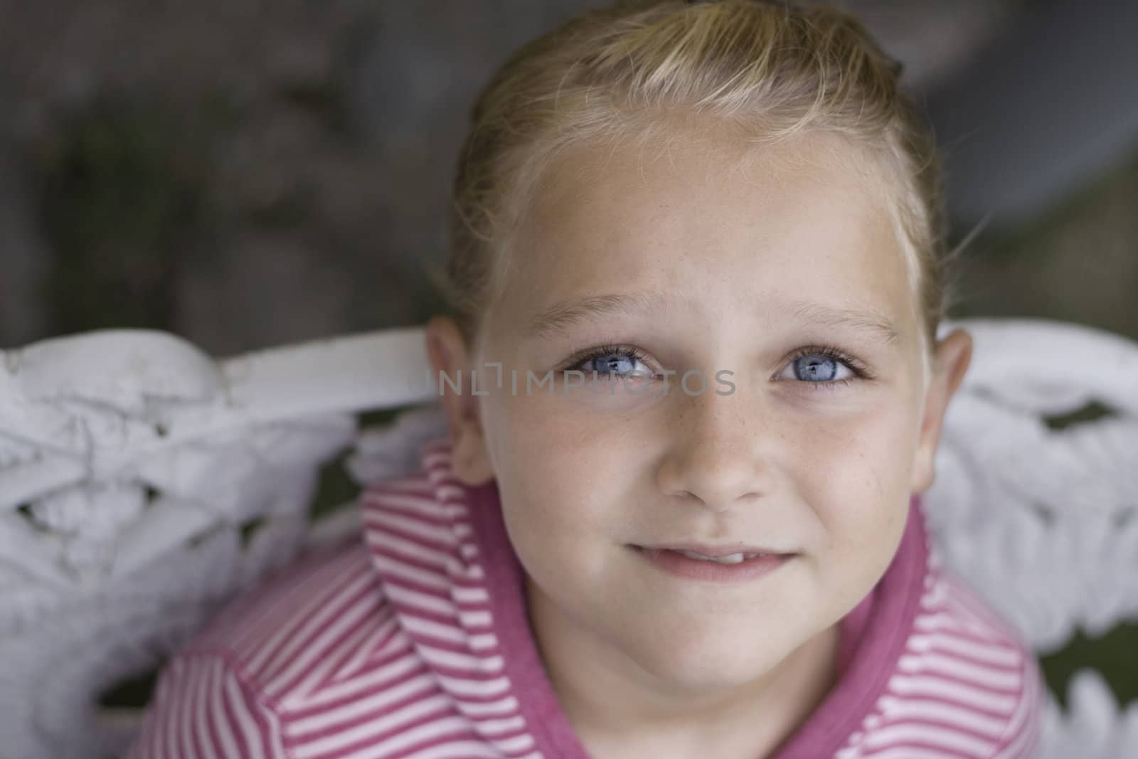 Soft focus horizontal of a girl aged 8, looking away from the camera