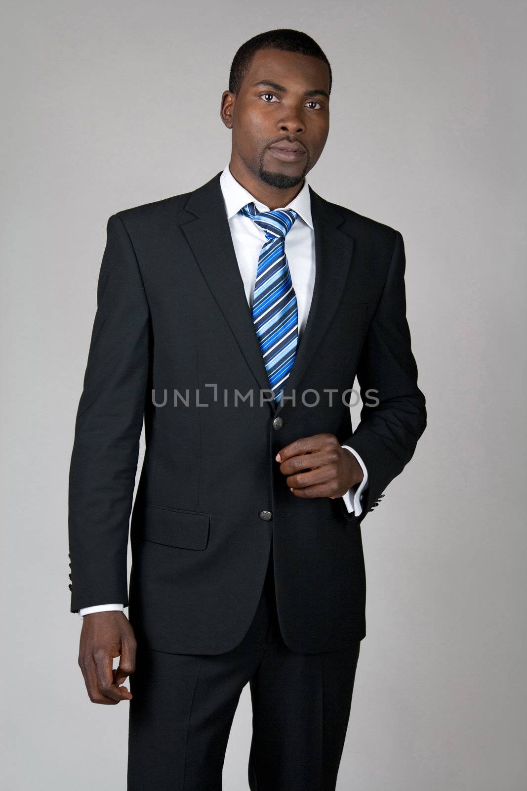 Elegant African American gentleman wearing suit and tie.