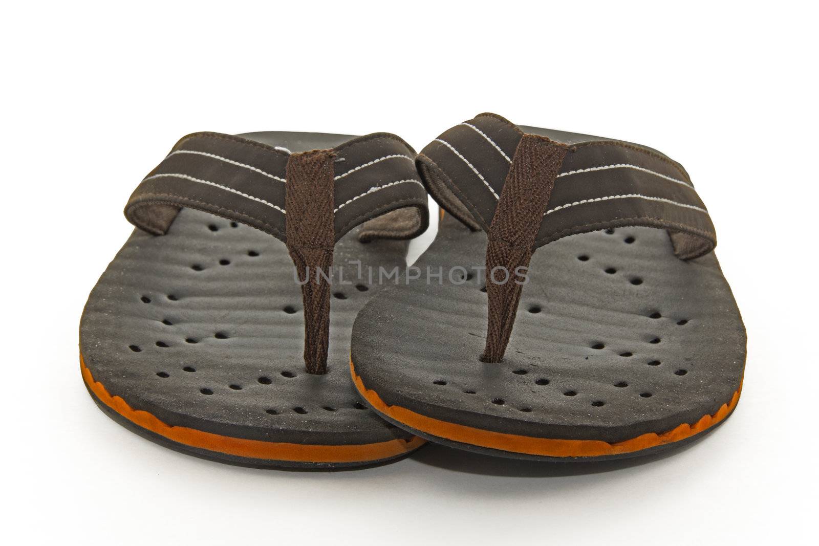 Gently used comfortable brown flip flops with a fabric strap on a white background