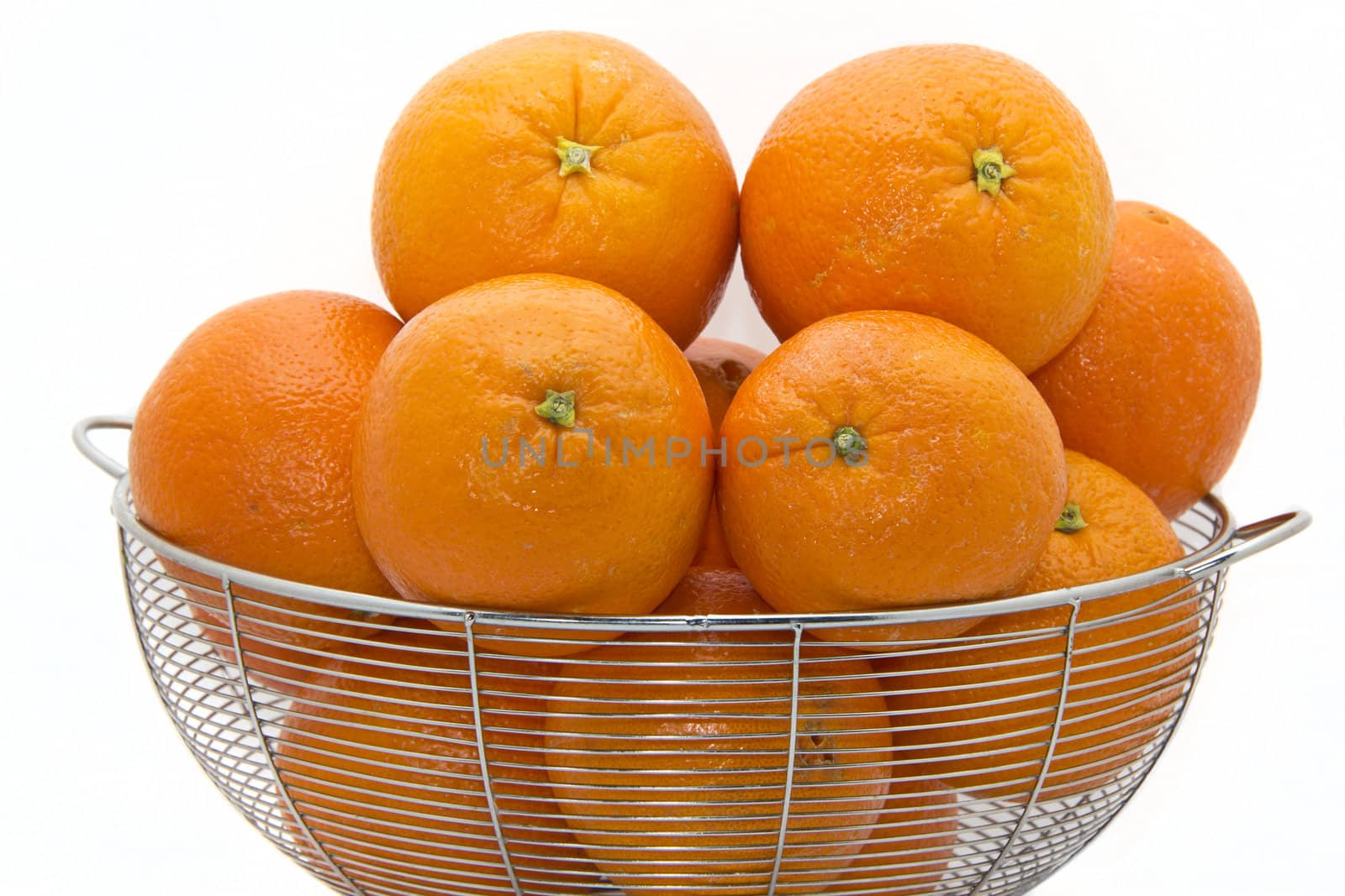 Delicious ripe Florida oranges stacked up on a white plate