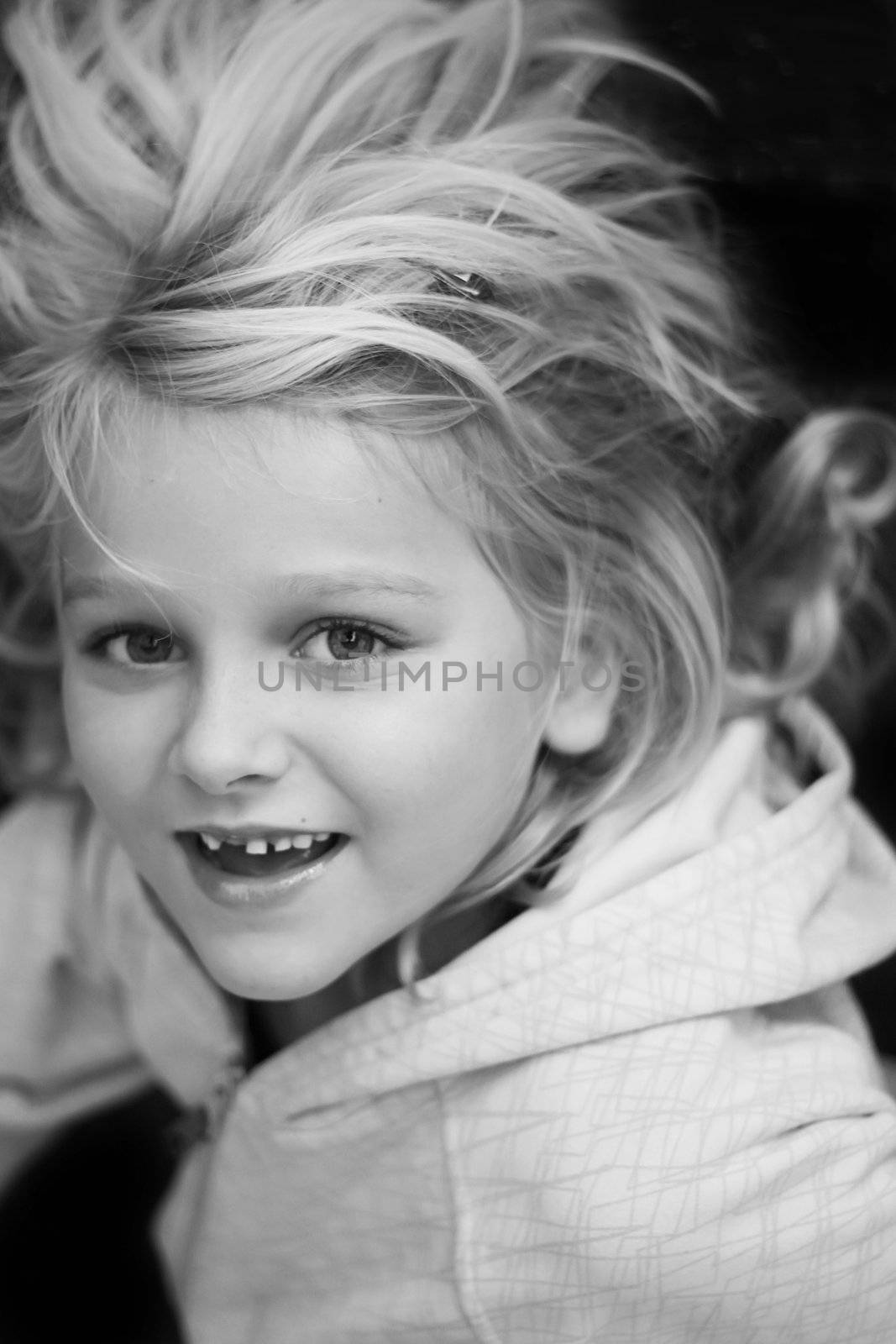 Black and white portrait of a girl without one front tooth