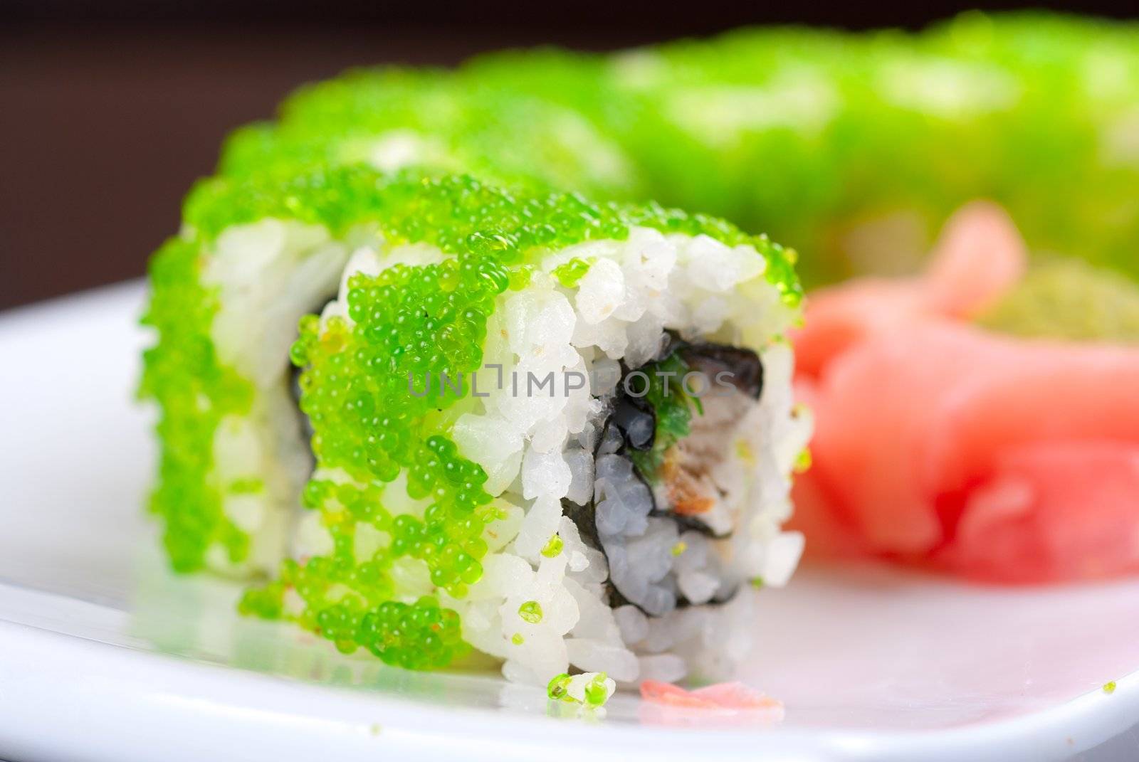 Sushi rolls made of salmon, avocado, flying fish roe - tobiko caviar and philadelphia cheese