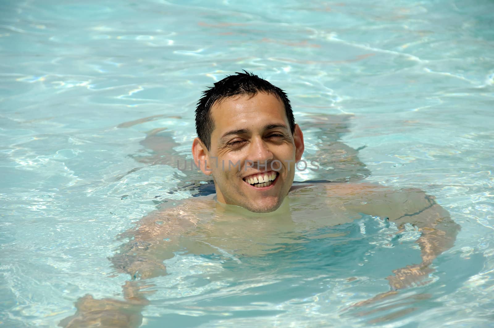 A happy man in a swimming pool