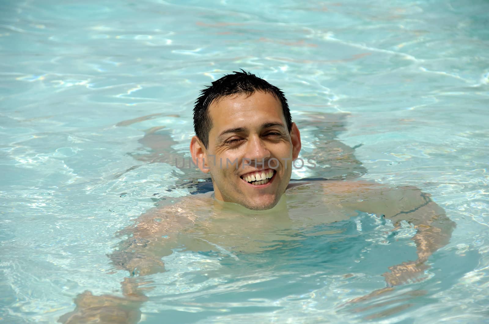 Happy man in pool by cfoto