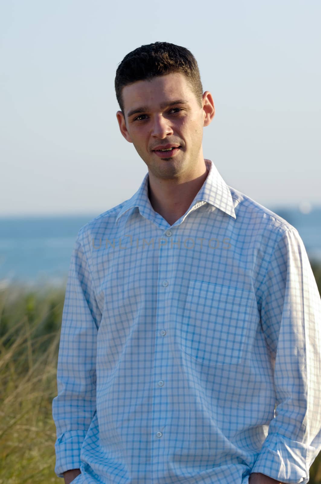 Young man smiling by cfoto