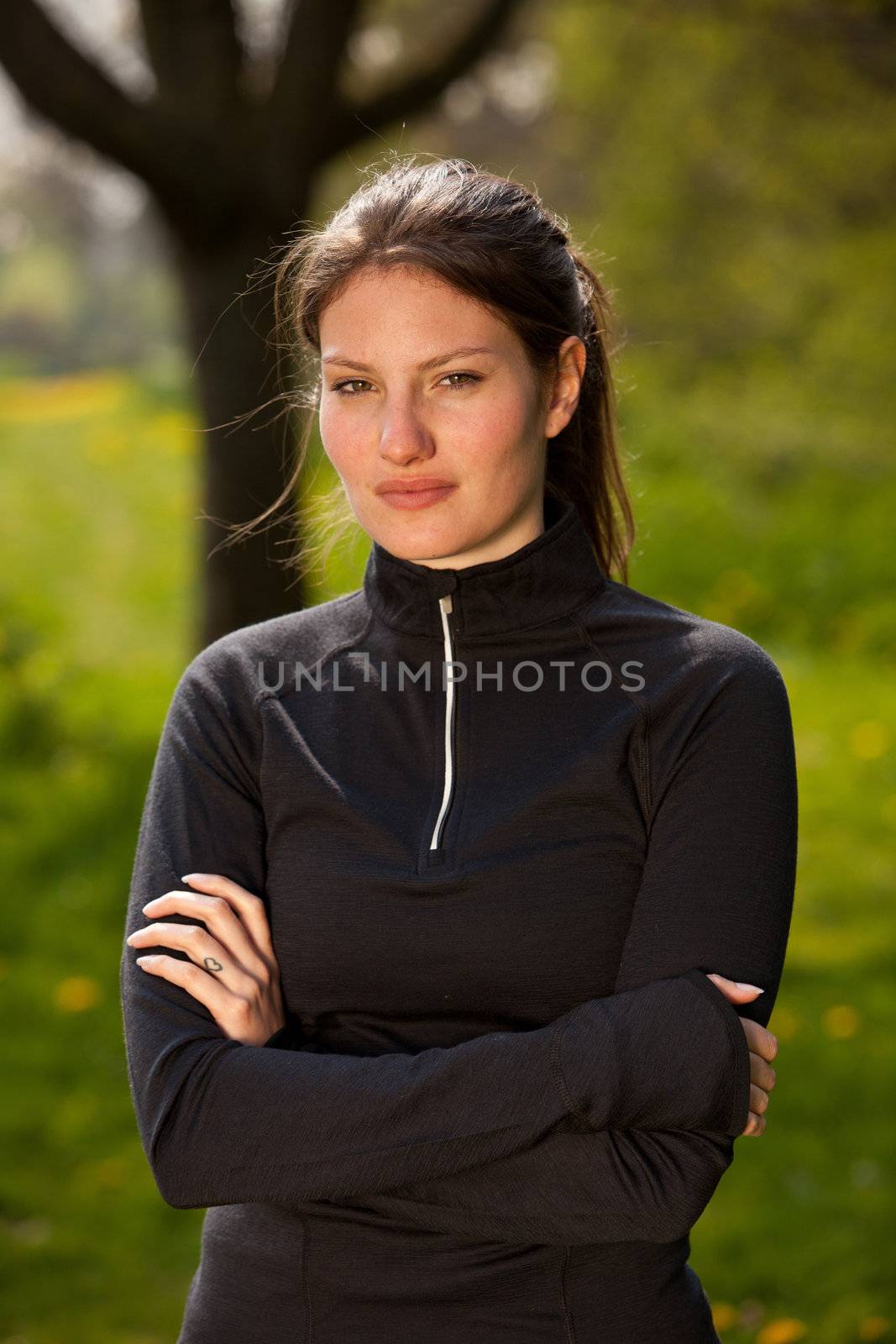 Sporty girl in sportswear standing outside