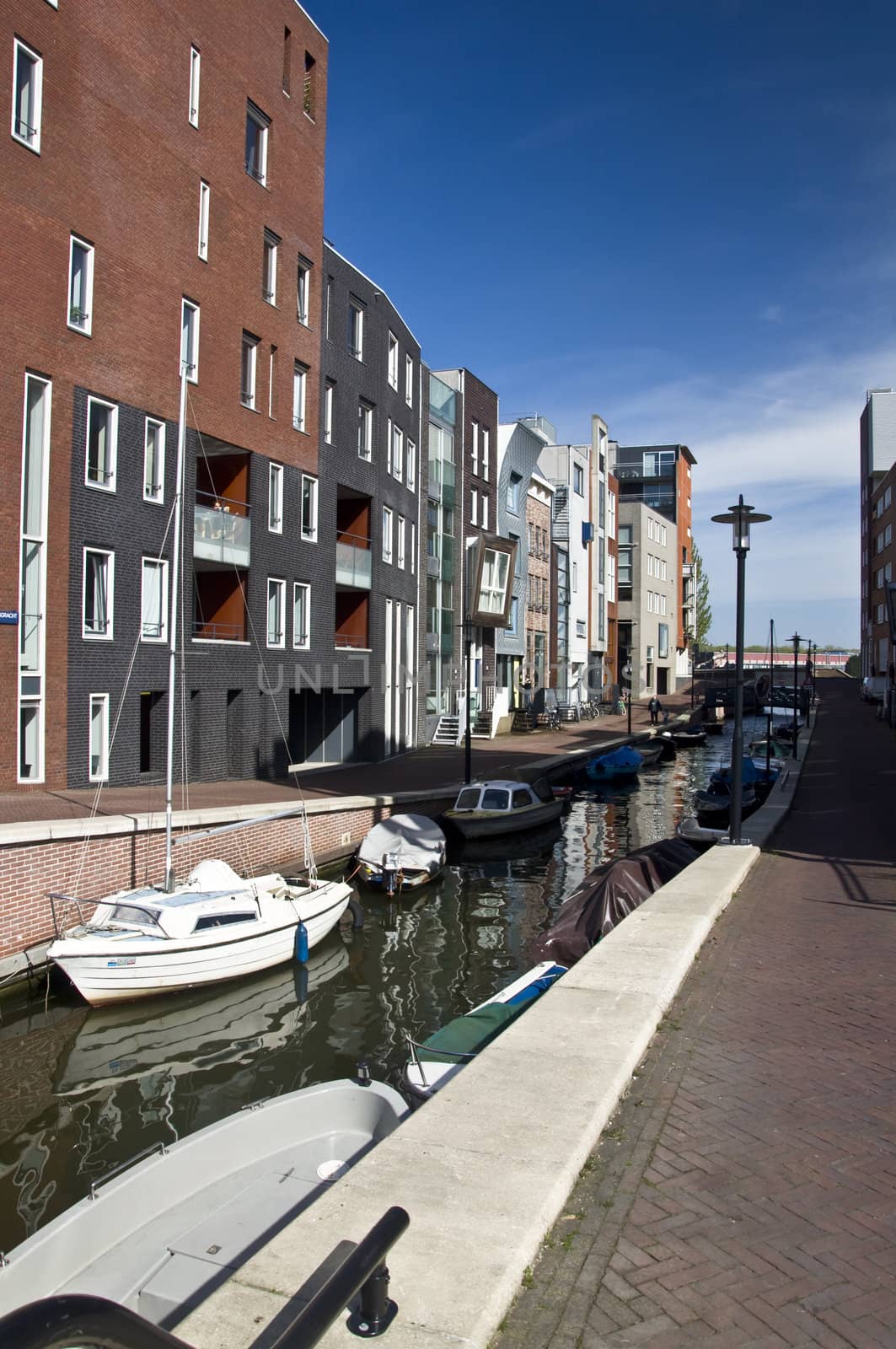 Modern residential houses on the canal in Amsterdam. Spring cityscape.