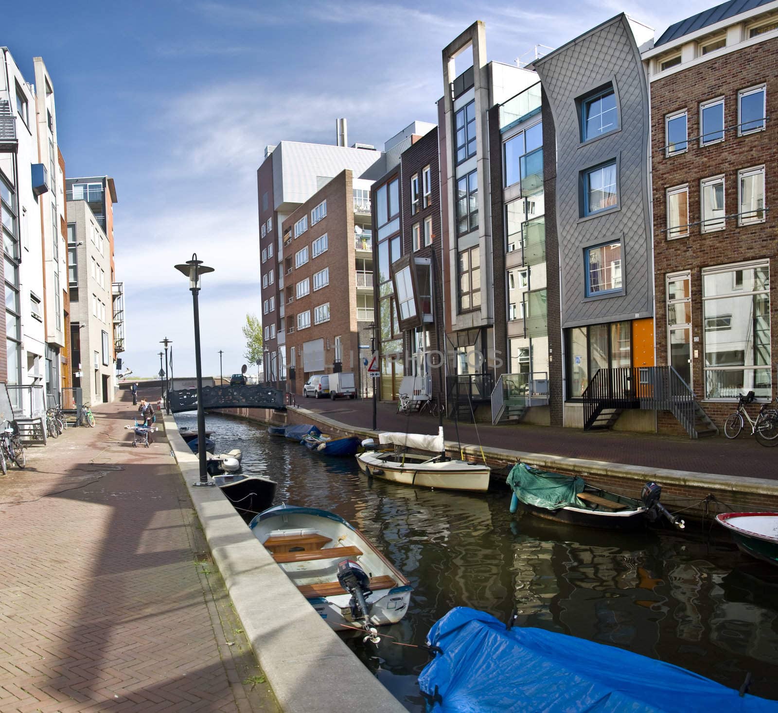 Modern residential houses on the canal in Amsterdam. Spring cityscape.