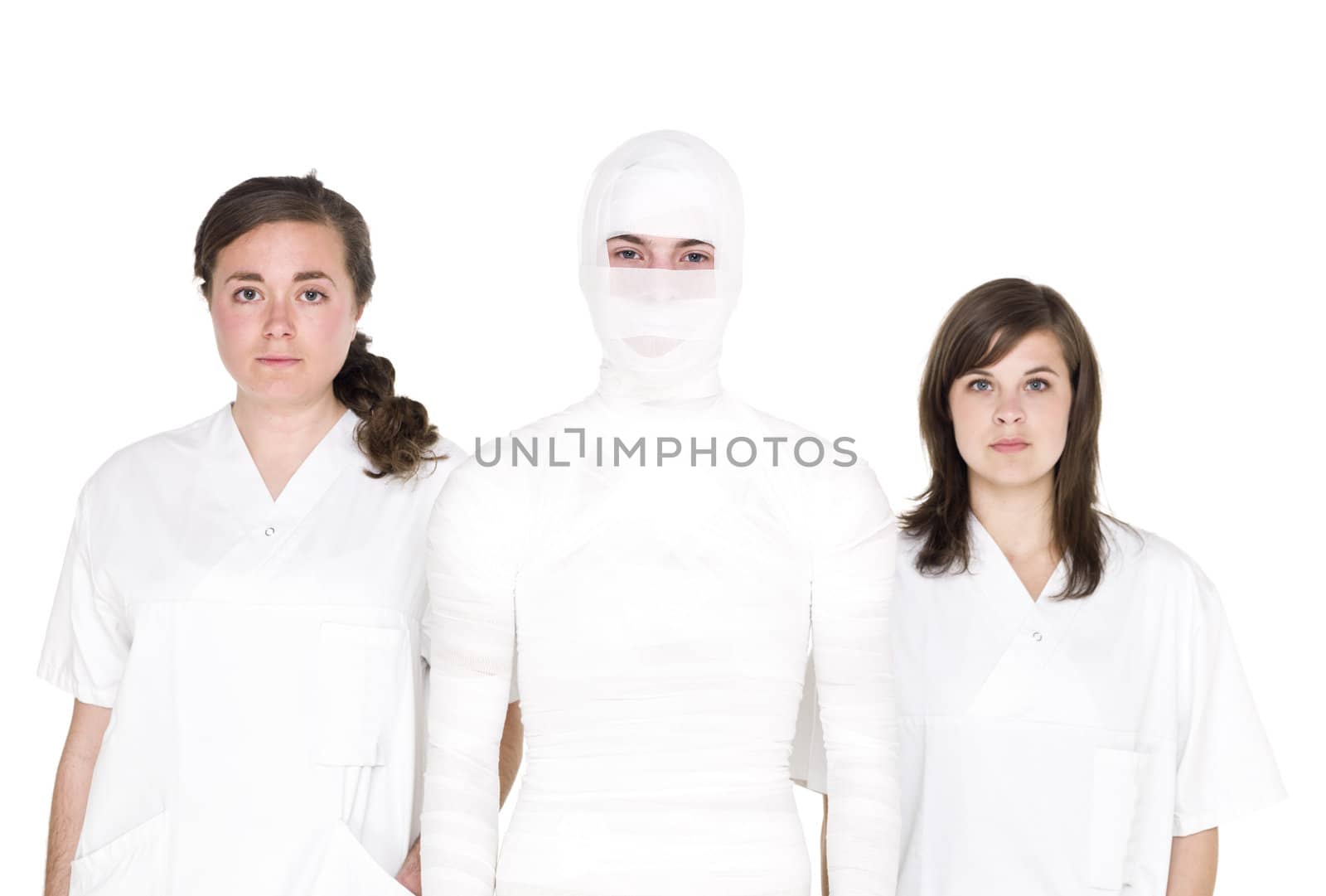 Mummified person with two female nurses