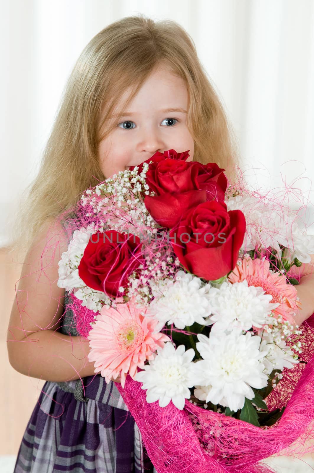 beautiful little girl with a bouquet of flowers