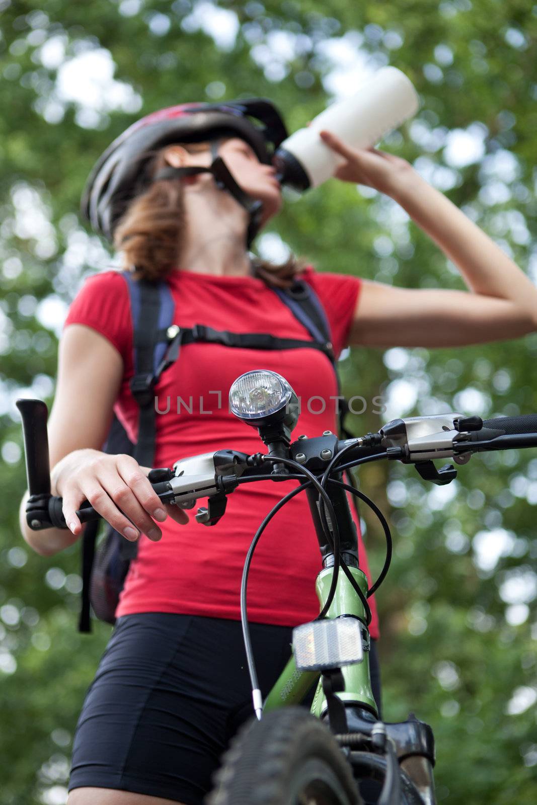 pretty young female biker outddors on her mountain bike by viktor_cap
