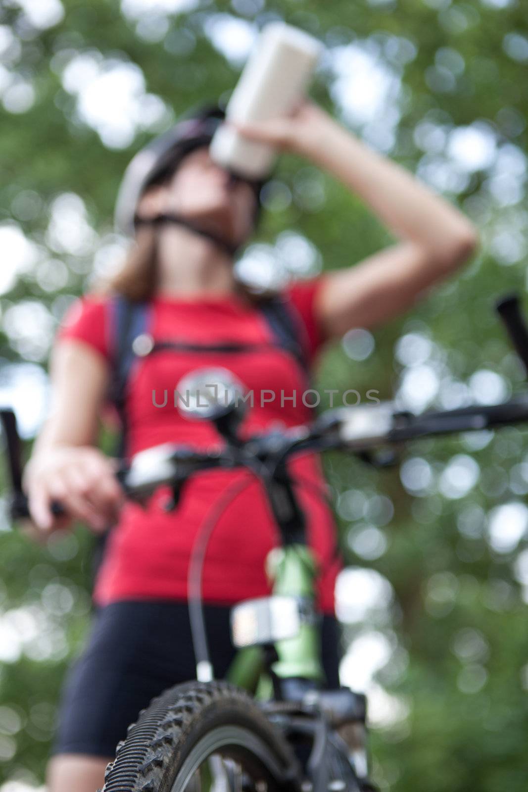 pretty young female biker outddors on her mountain bike (shallow DOF; selective focus)