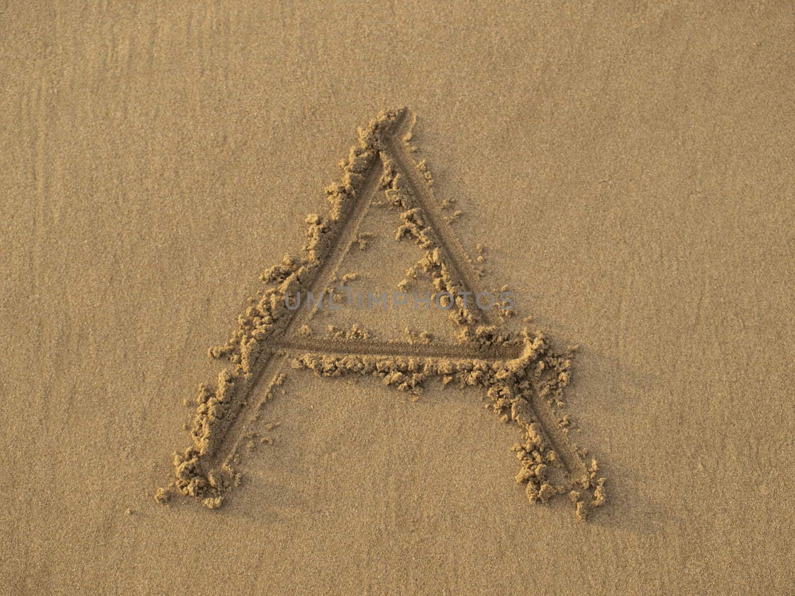 Alphabet starts with letter A hand written on the beach