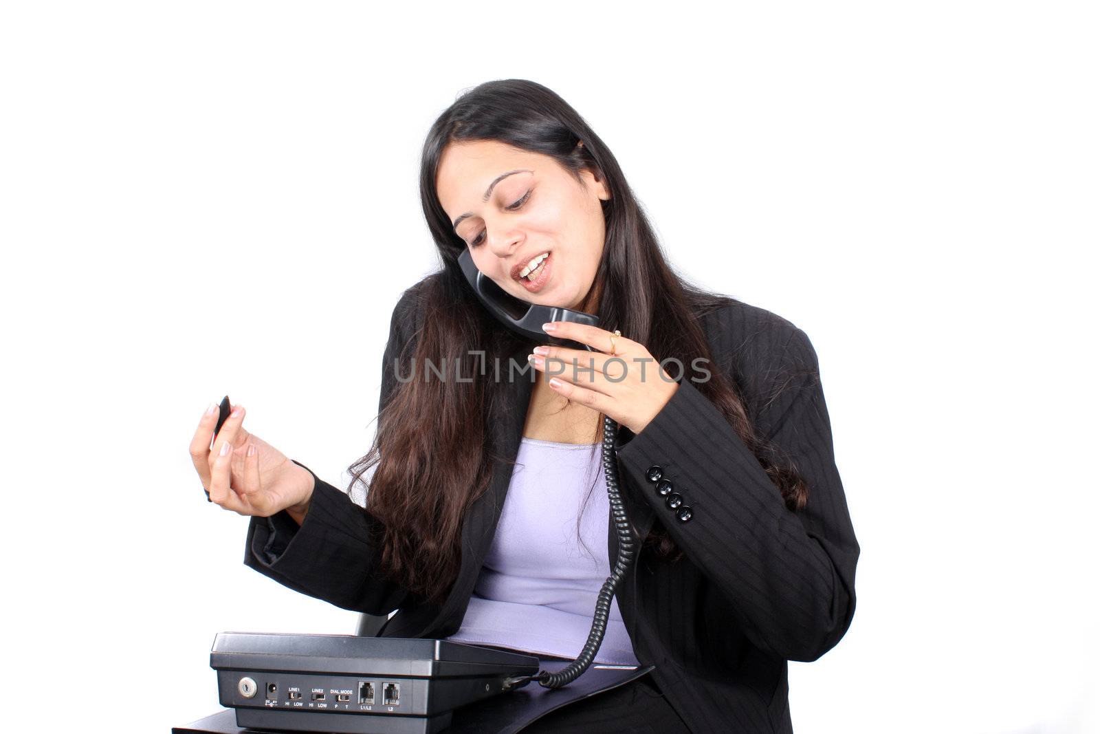 A beautiful Indian office executive burdened with workload.