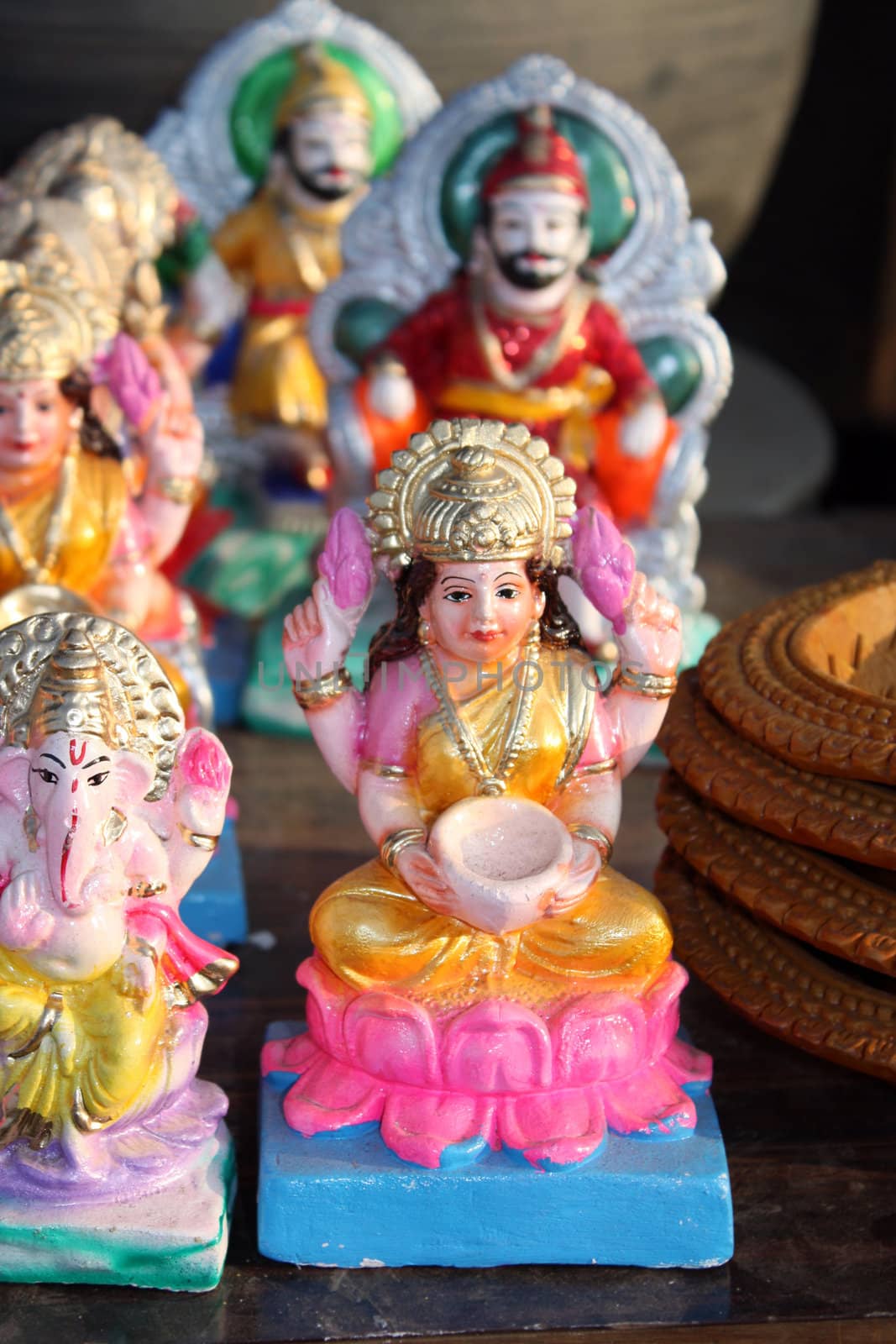 An idol of goddess laxmi along with other mythological and historical figures from Hinduism, at a potters shop.