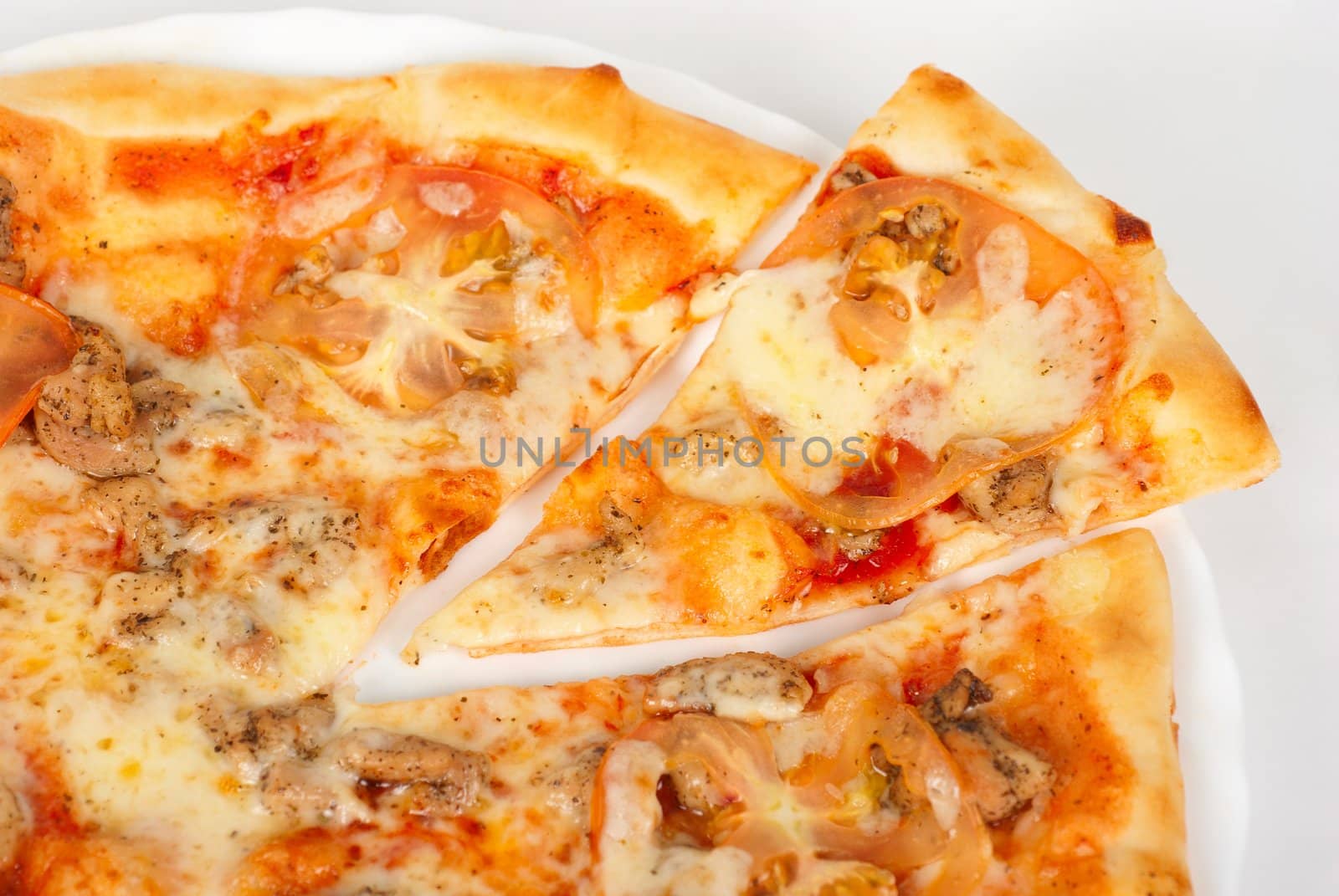 pizza closeup with chicken fillet, tomato and mozzarella cheese