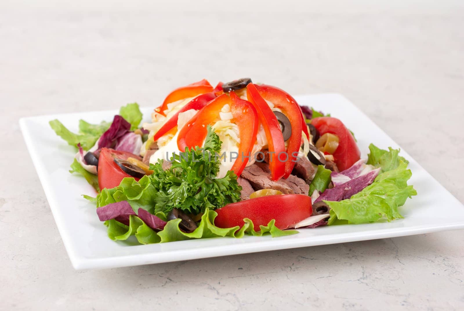 spicy salad of roast beef with potato, tomato, cabbage, pepper and lettuce