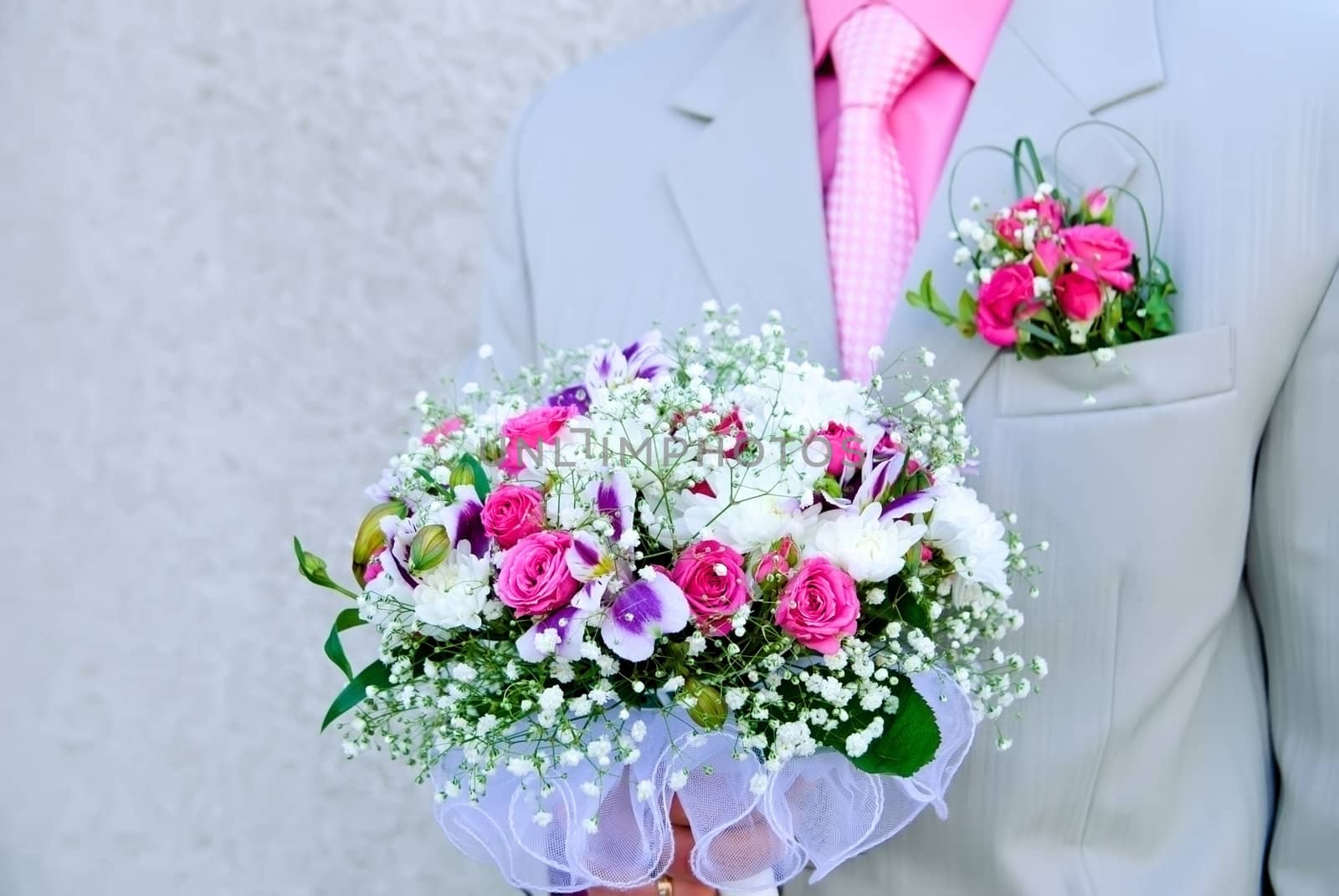 Bridal bouquet in the hand of the groom