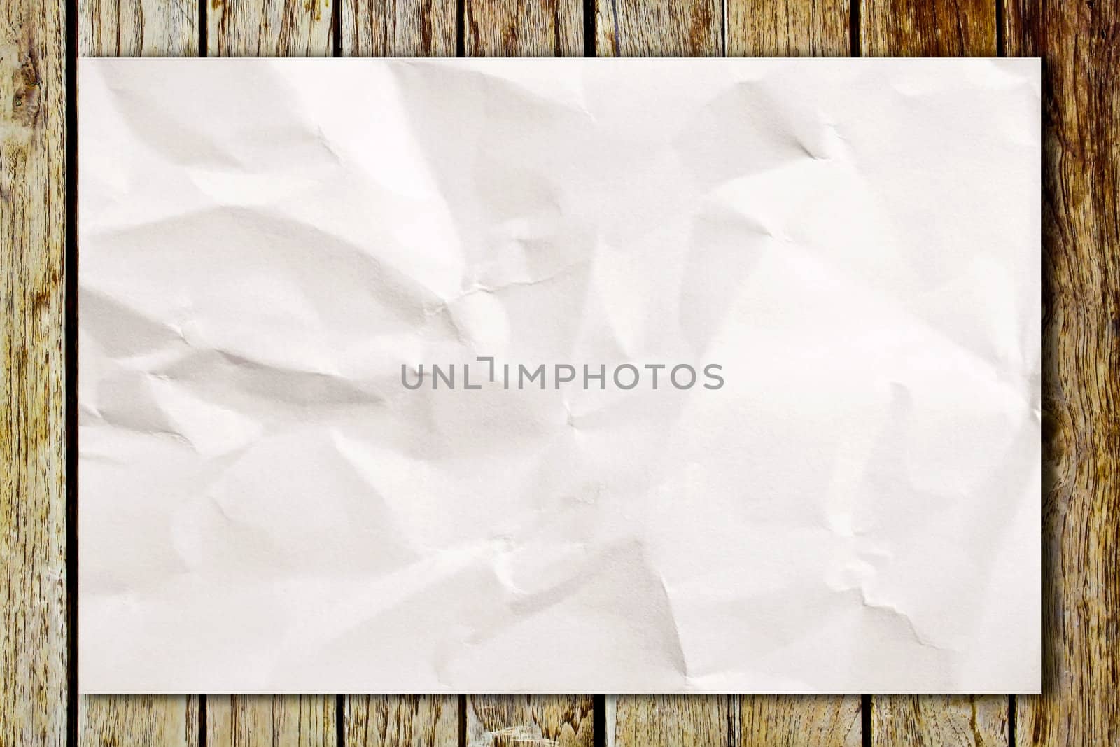 Blank crumpled white paper on wooden table