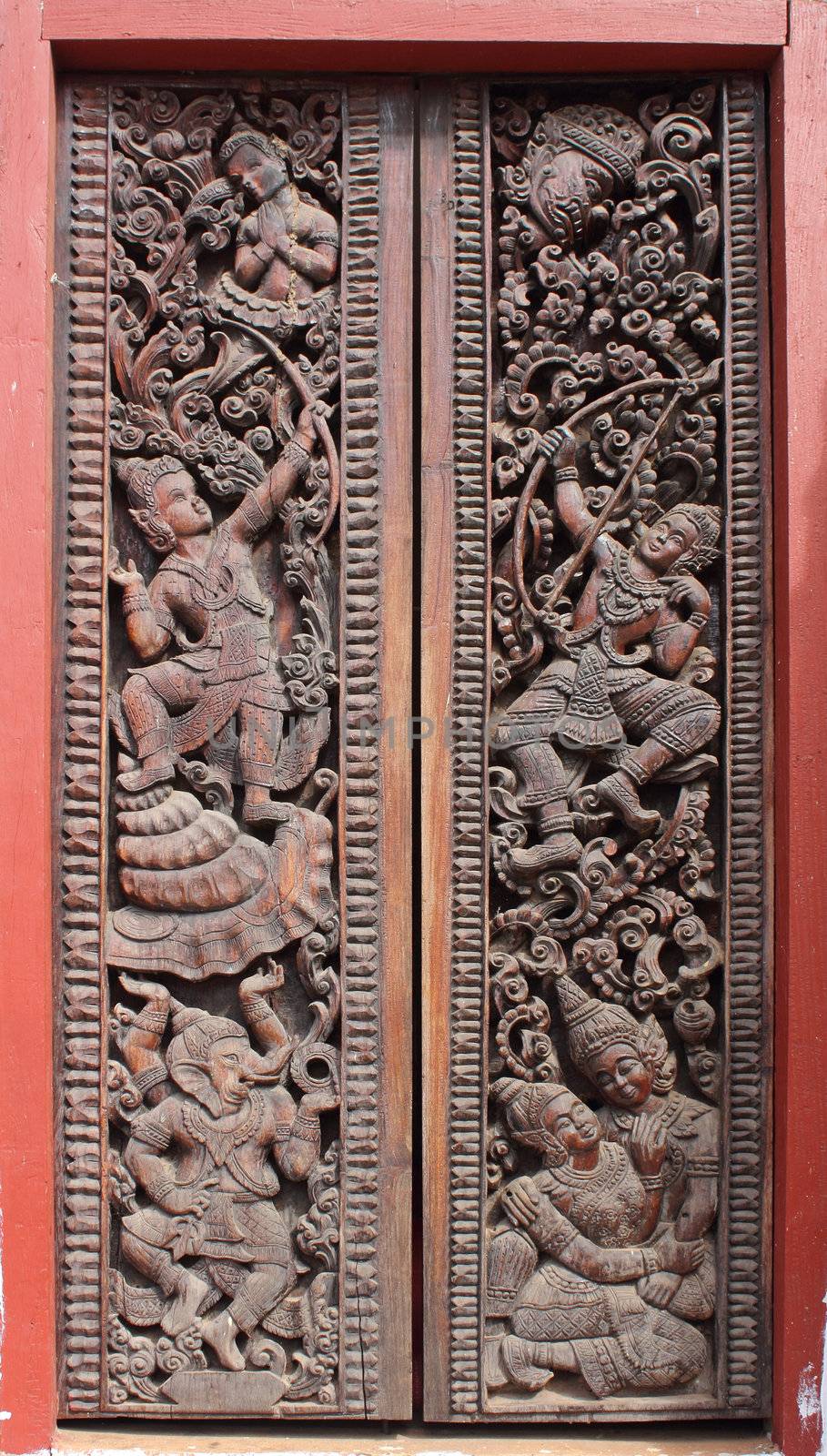 Decorated wooden door in Buddhist temple, Laos
