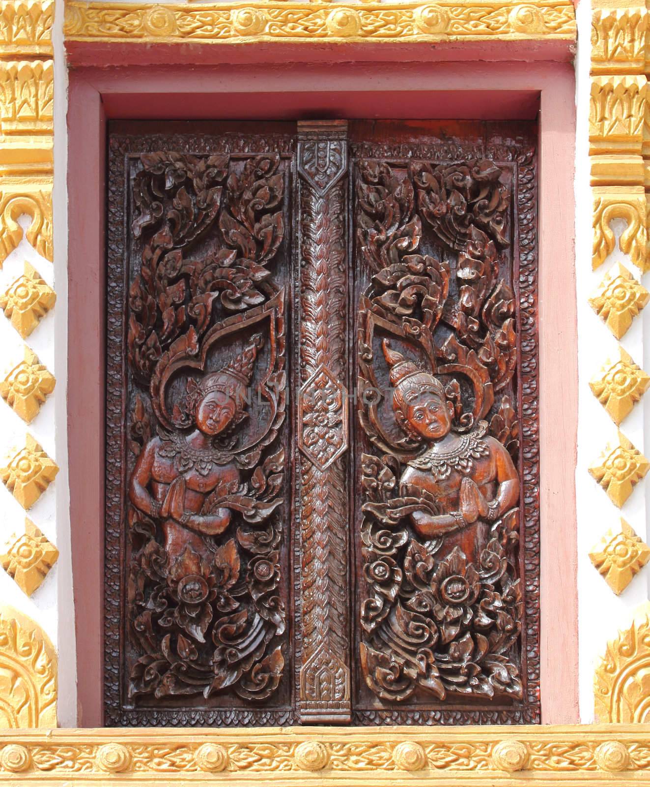 Delicate and elaborated detailed of the Buddhist monastery window, Laos