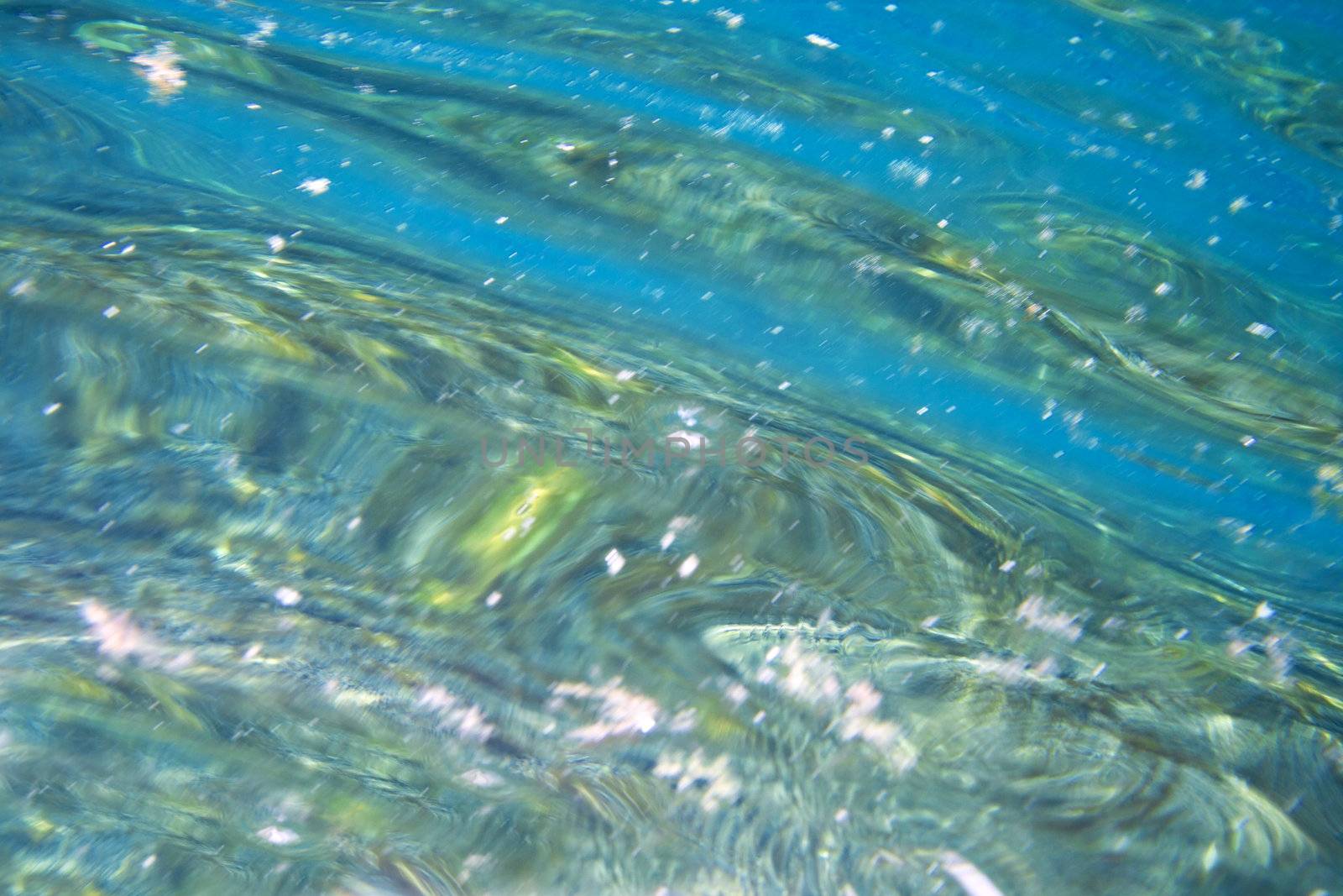 Seabed reflection on the water surface under water.