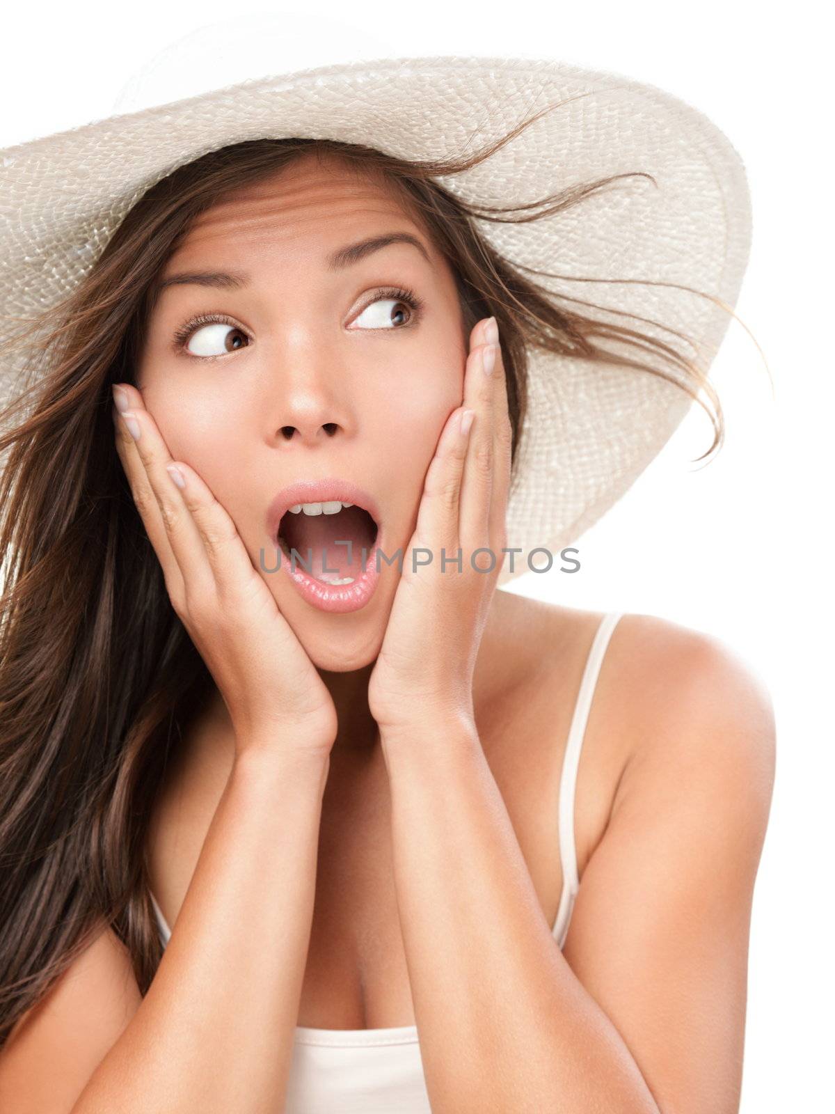 Woman shocked looking to the side copy space. Surprised summer woman weating beach hat. Portrait of mixed race asian caucasian model isolated on white background.