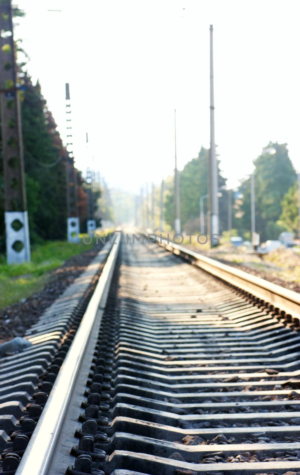 Railway recedes into the distance in a sunny day