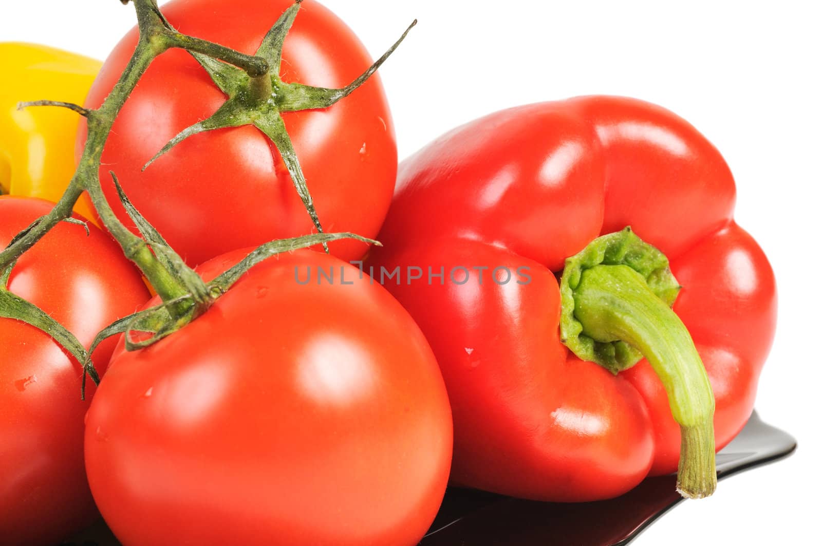 Vegetables - Tomatoes, peppers on a plate with dill. Isolated on white.