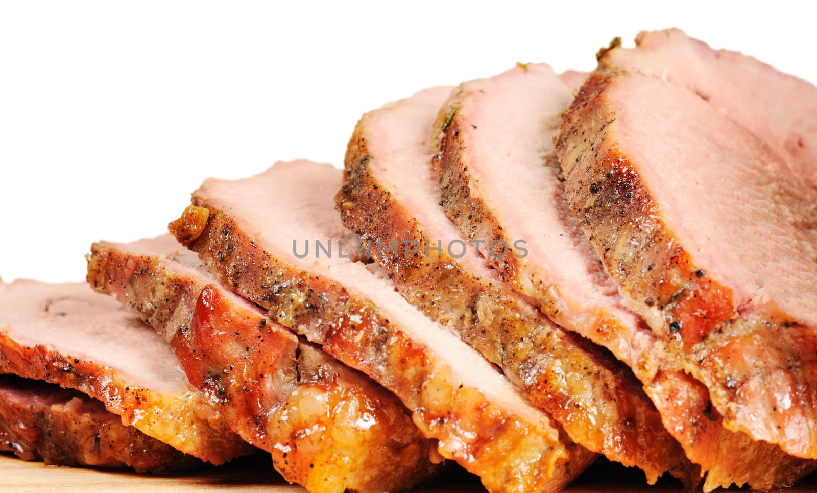 Roast pork on a wooden board. Isolated on white.