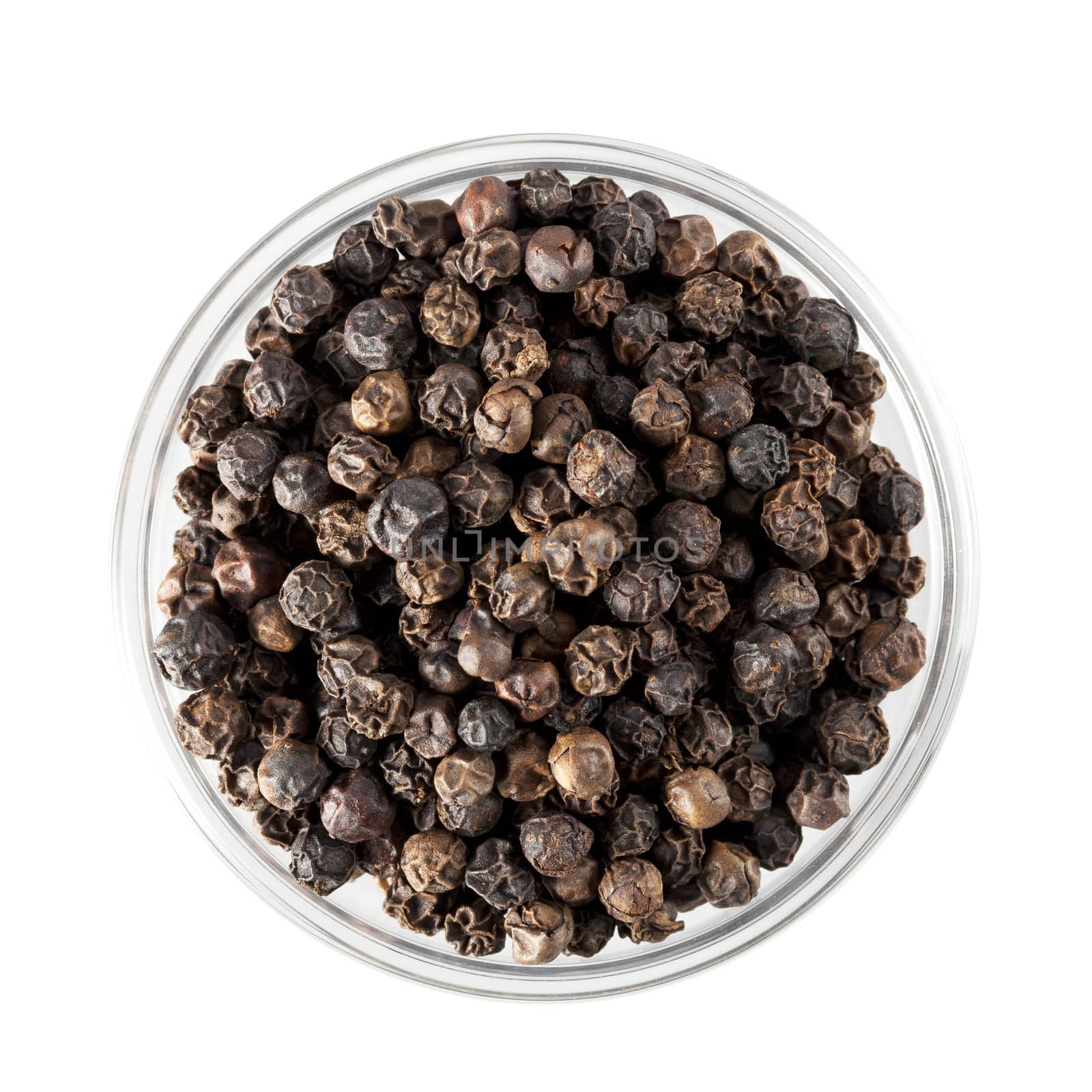 Black peppercorns in glass bowl, isolated and shot from directly above.