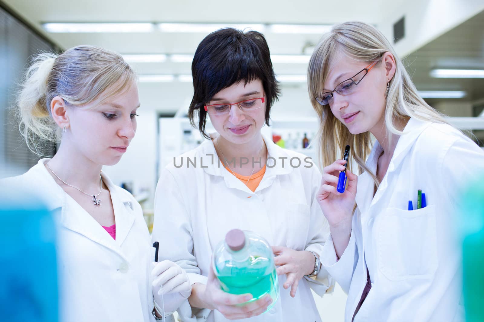 portrait of a female researcher carrying out research in a chemistry lab (color toned image; shallow DOF)